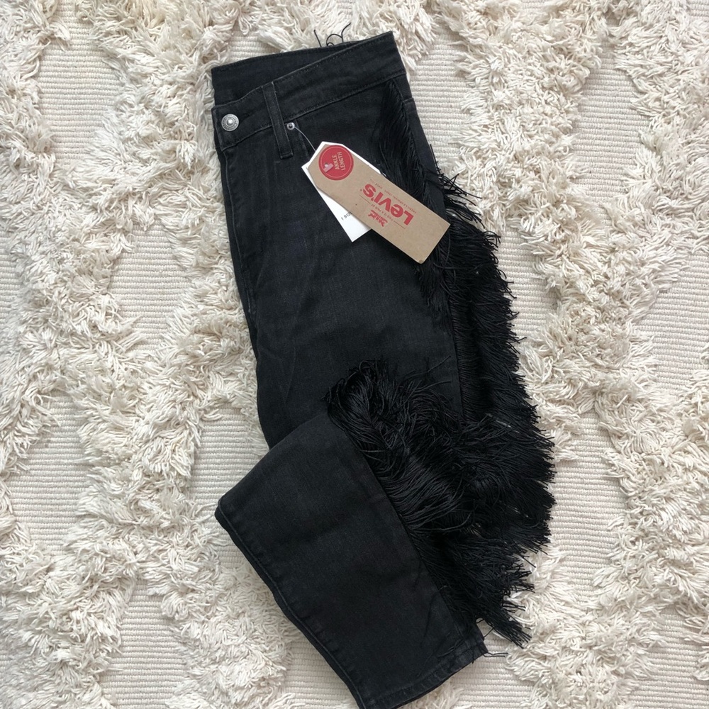 Levi’s black jeans with black side fringe.